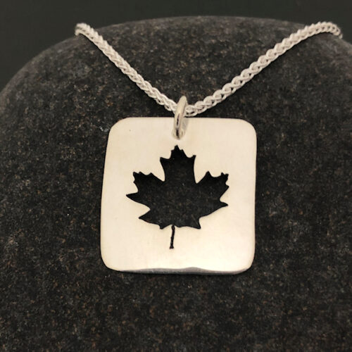 Maple-Leaf-Pendant-Square-with-chain-on-stone